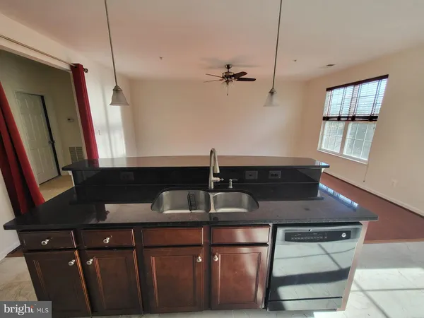 a kitchen with a sink and a refrigerator