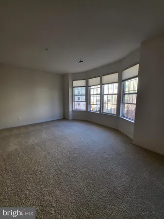 an empty room with a empty space and windows
