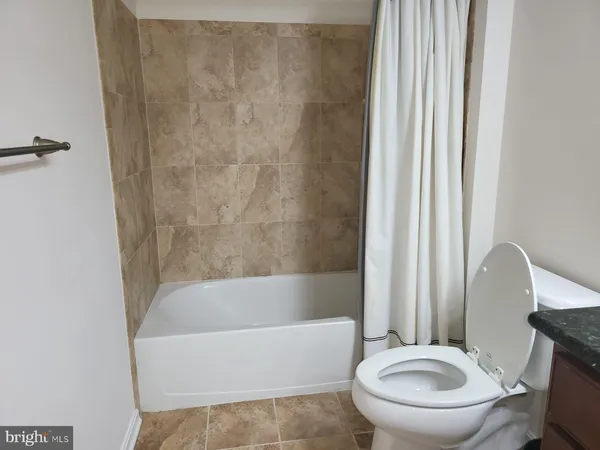 a bathroom with a sink a toilet and bathtub