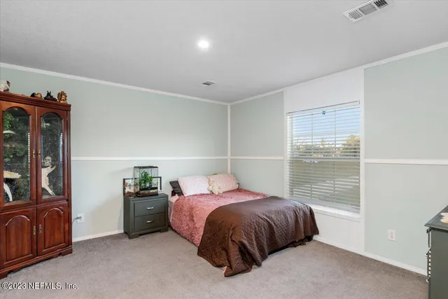 a bedroom with a bed and dresser