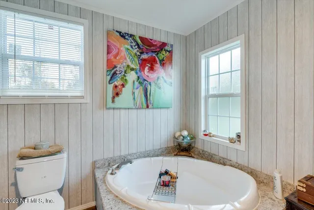 a white bath tub sitting next to a window