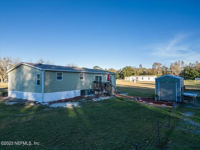 a view of a backyard with plants and a garden