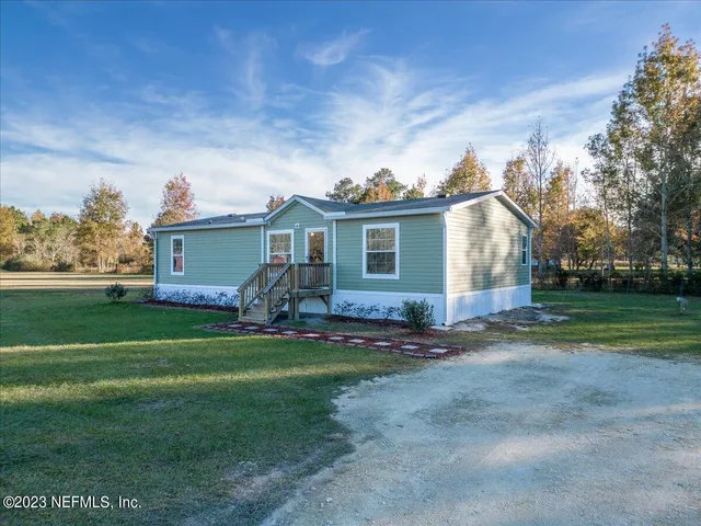 a front view of house with yard and green space