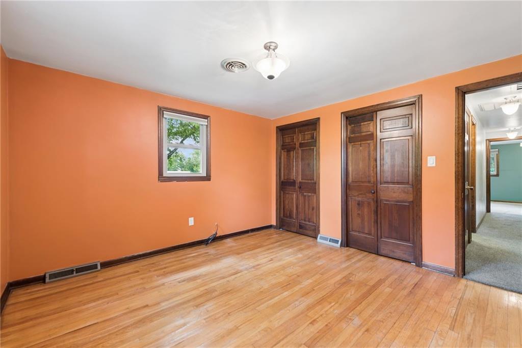 22 Buzzardtown Road Irwin, PA 15642 - Photo 23 of 44 a view of empty room with wooden floor and fan