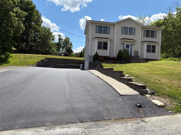 a view of house with yard