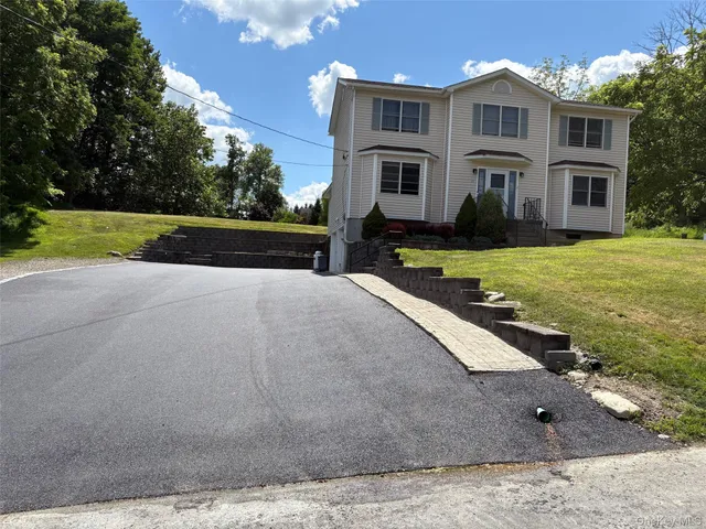 a view of house with yard