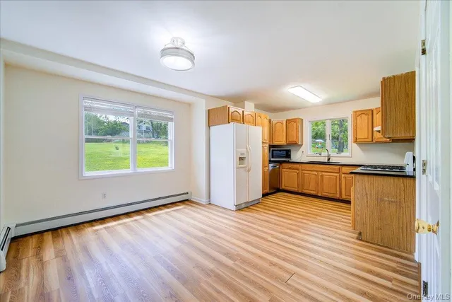 a view of kitchen with wooden floor and window