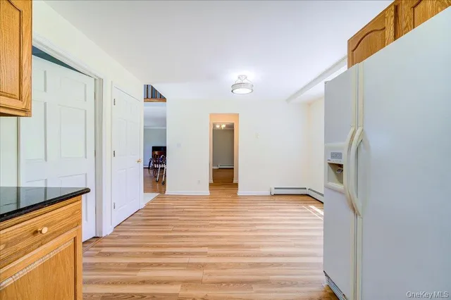 a view of a kitchen with a sink and refrigerator