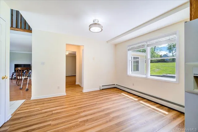 a view of a livingroom with wooden floor and a ceiling fan