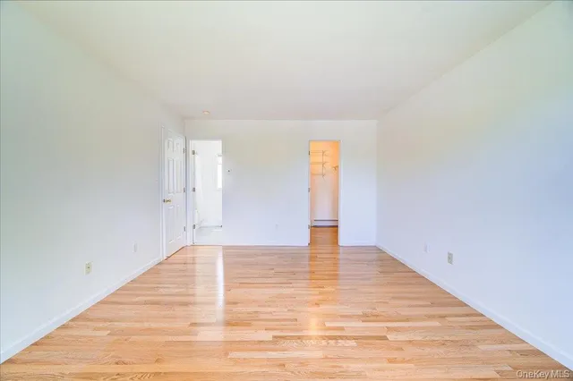 a view of an empty room and wooden floor