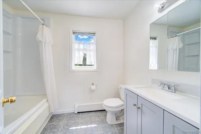 a bathroom with a sink a toilet and bathtub