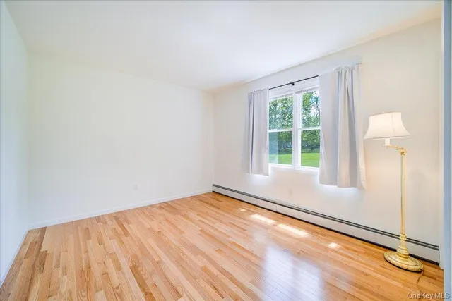 a view of room with window and wooden floor