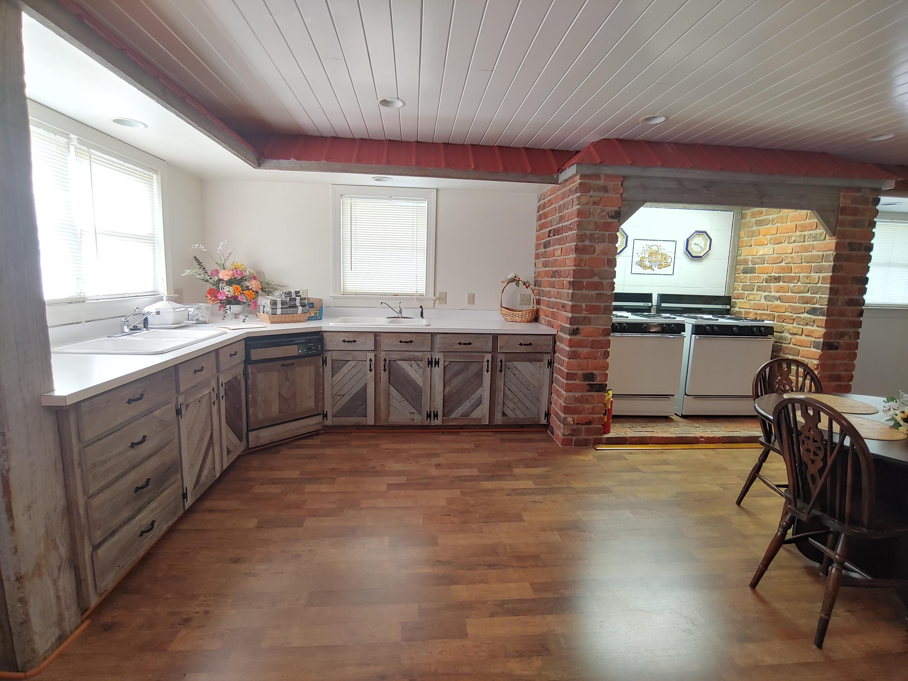 136 Old Fields Road Southwest Floyd, VA 24091 - Photo 40 of 71 a large kitchen with stainless steel appliances granite countertop a stove a sink and a dishwasher next to a window