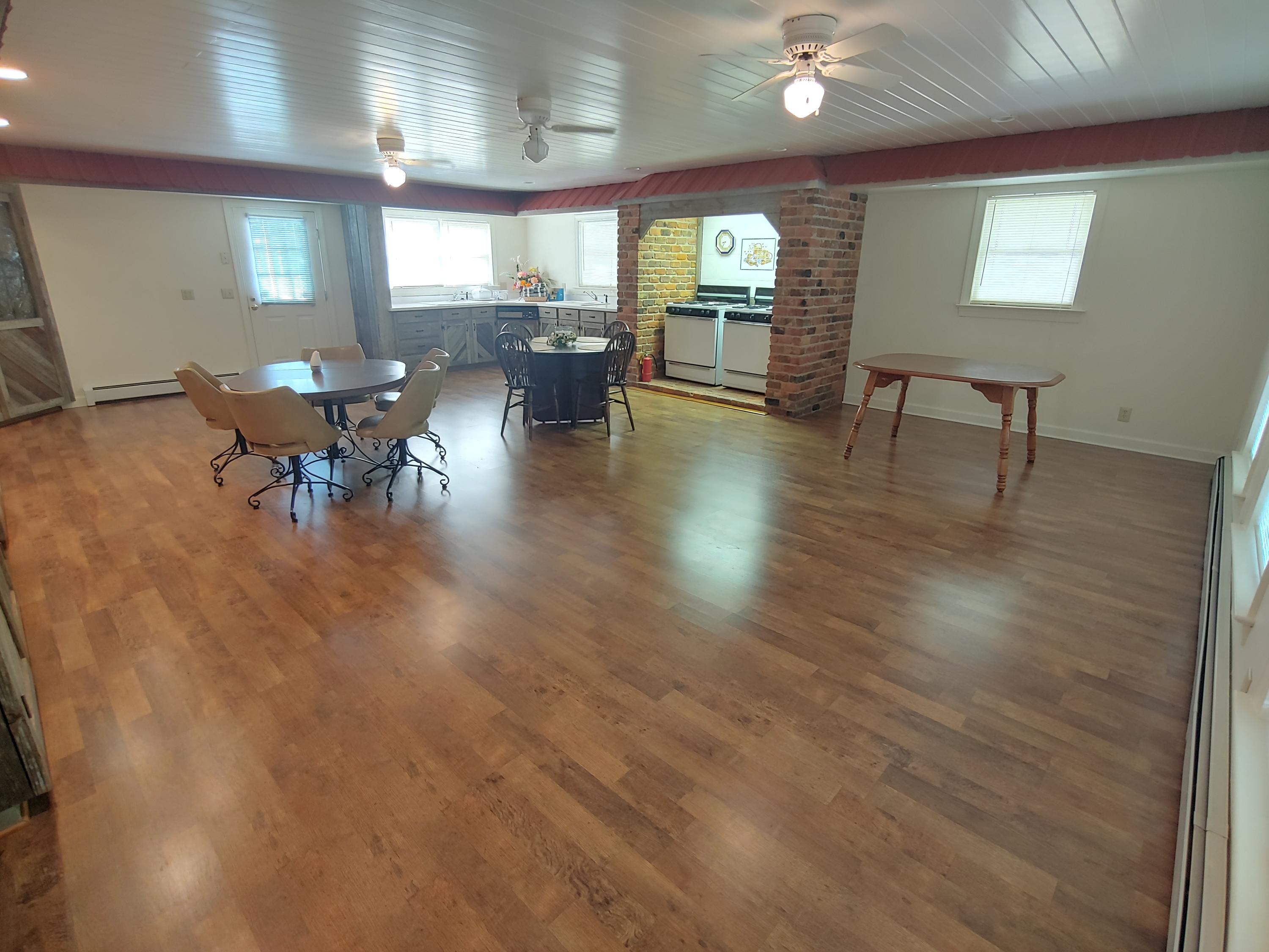 136 Old Fields Road Southwest Floyd, VA 24091 - Photo 41 of 71 a living room with couches chairs and a dining table with wooden floor
