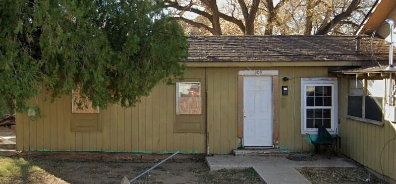 2101 Avenue M Lubbock, TX 79411 - Photo 2 of 3 a view of a wooden door and a tree