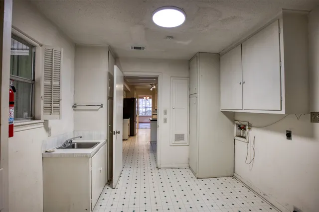 a view of empty room with wooden floor and fireplace
