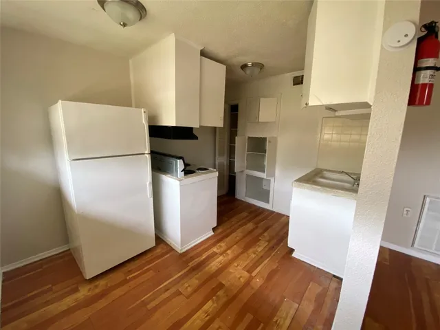 a kitchen with a refrigerator freezer and a dishwasher