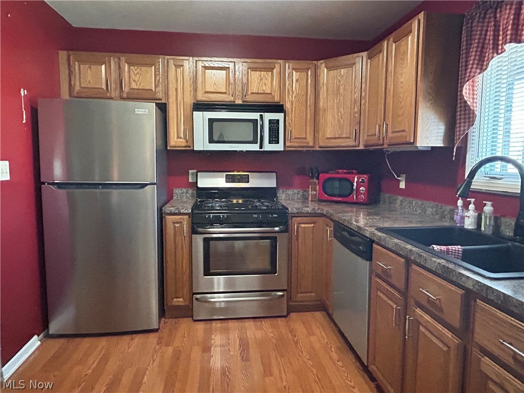 40 East Western Reserve Road, Unit 1 Youngstown, OH 44514 - Photo 9 of 33 Kitchen featuring light hardwood / wood-style flooring, appliances with stainless steel finishes, and sink