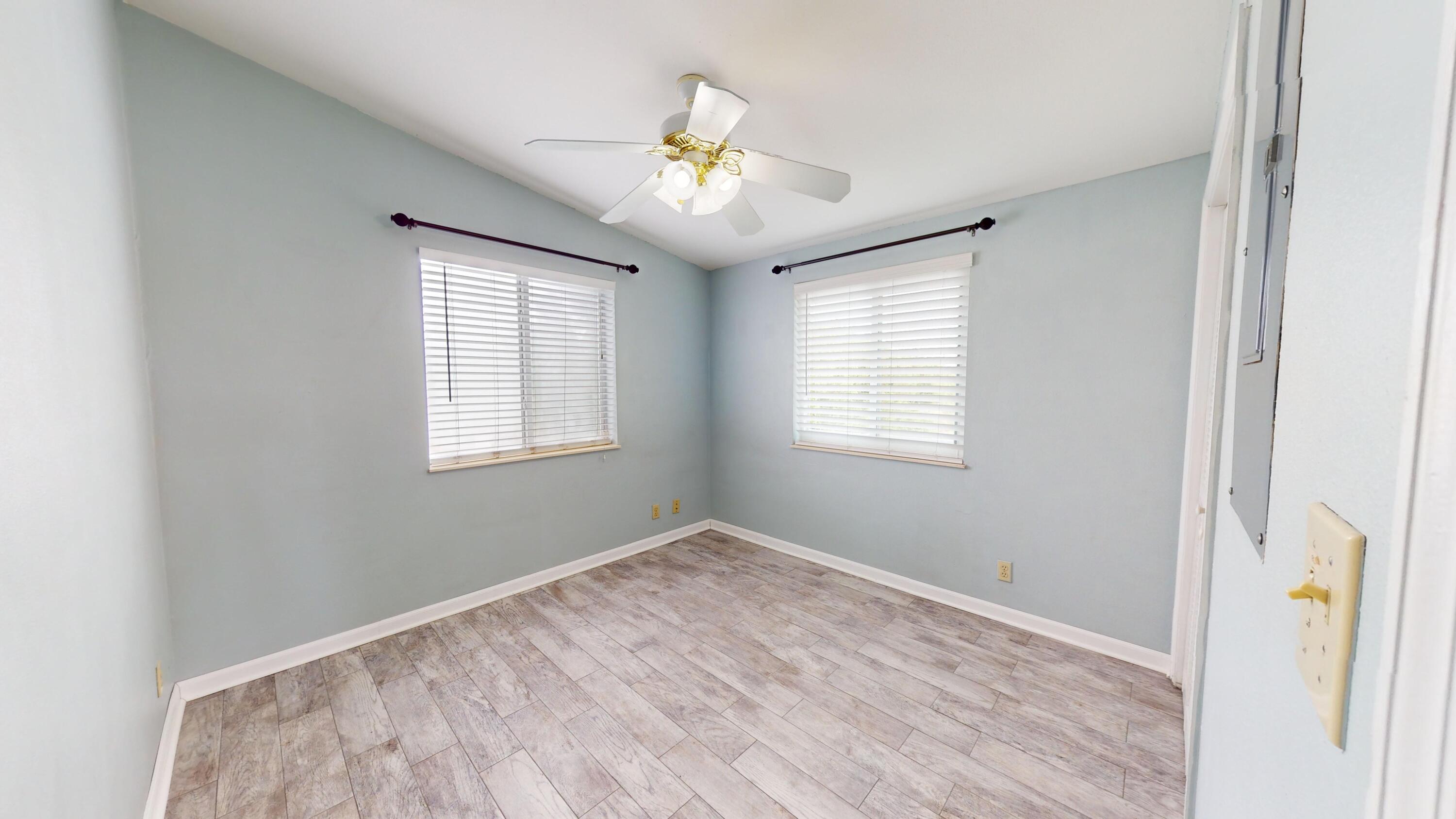 31163 Ave H Big Pine Key, FL 33043 - Photo 11 of 17 a view of empty room with wooden floor and fan