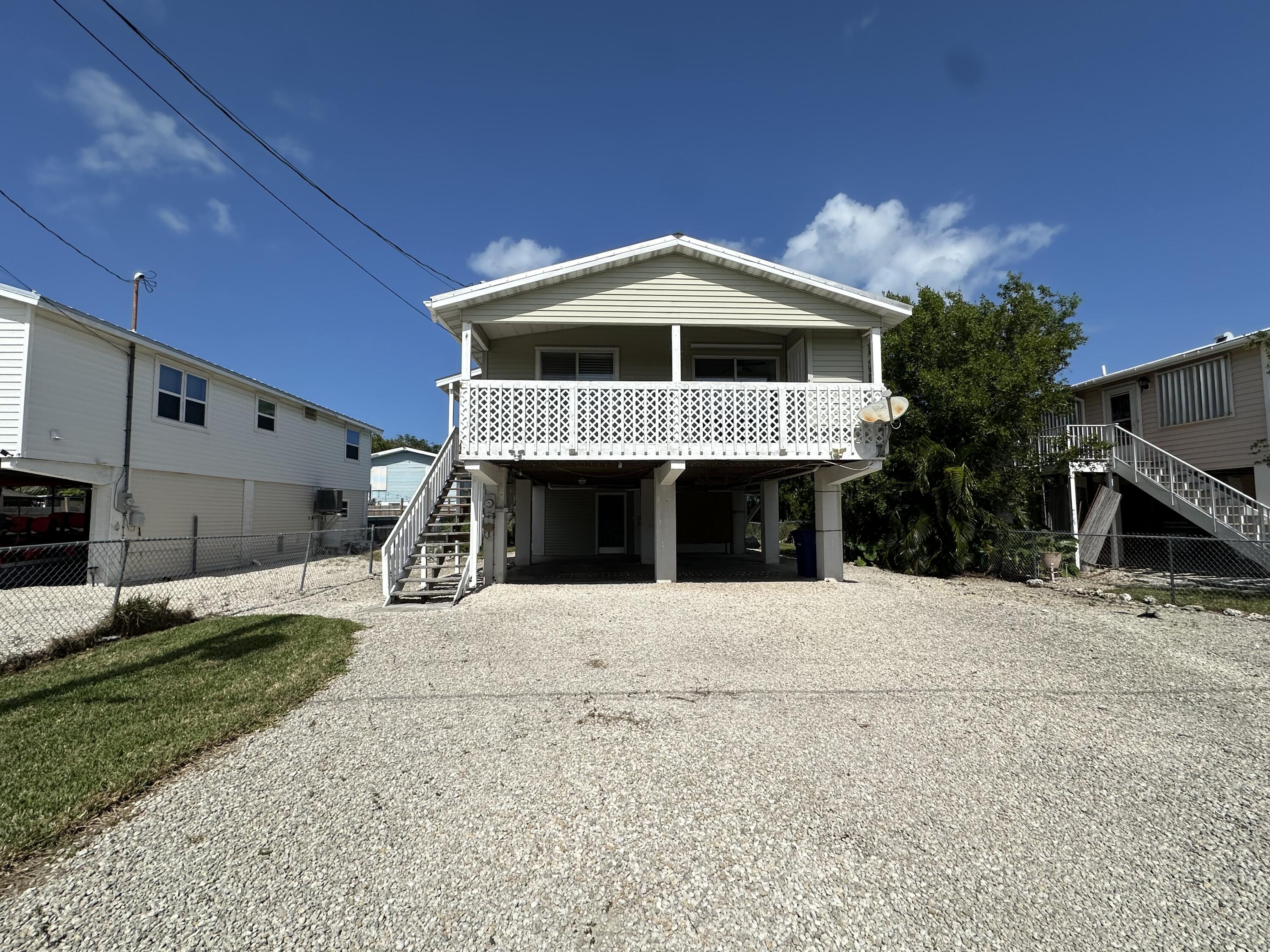 31163 Ave H Big Pine Key, FL 33043 - Photo 2 of 17 a front view of a house with a yard