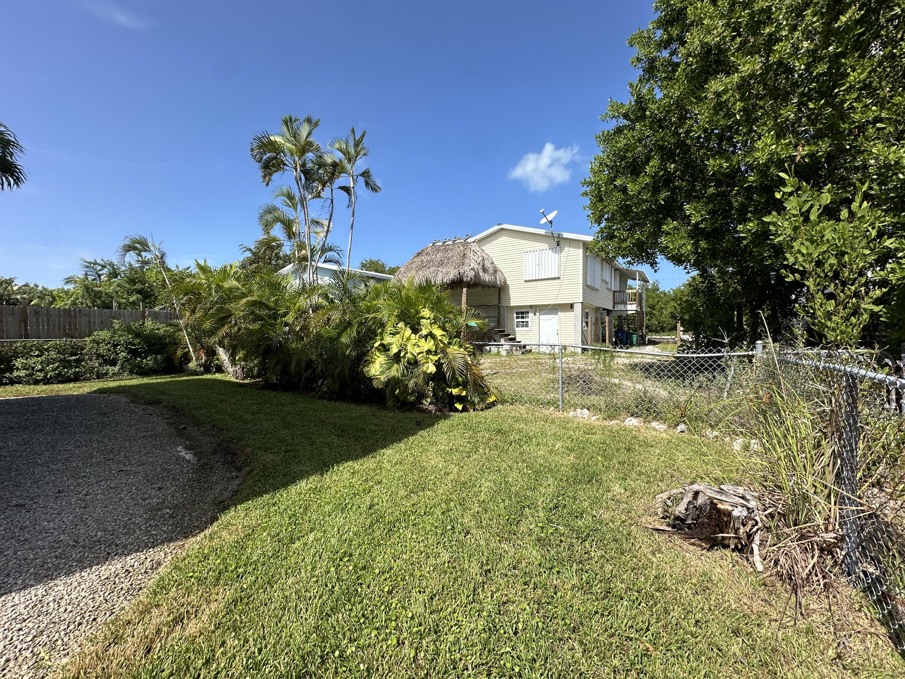31163 Ave H Big Pine Key, FL 33043 - Photo 3 of 17 a view of a garden with a fountain