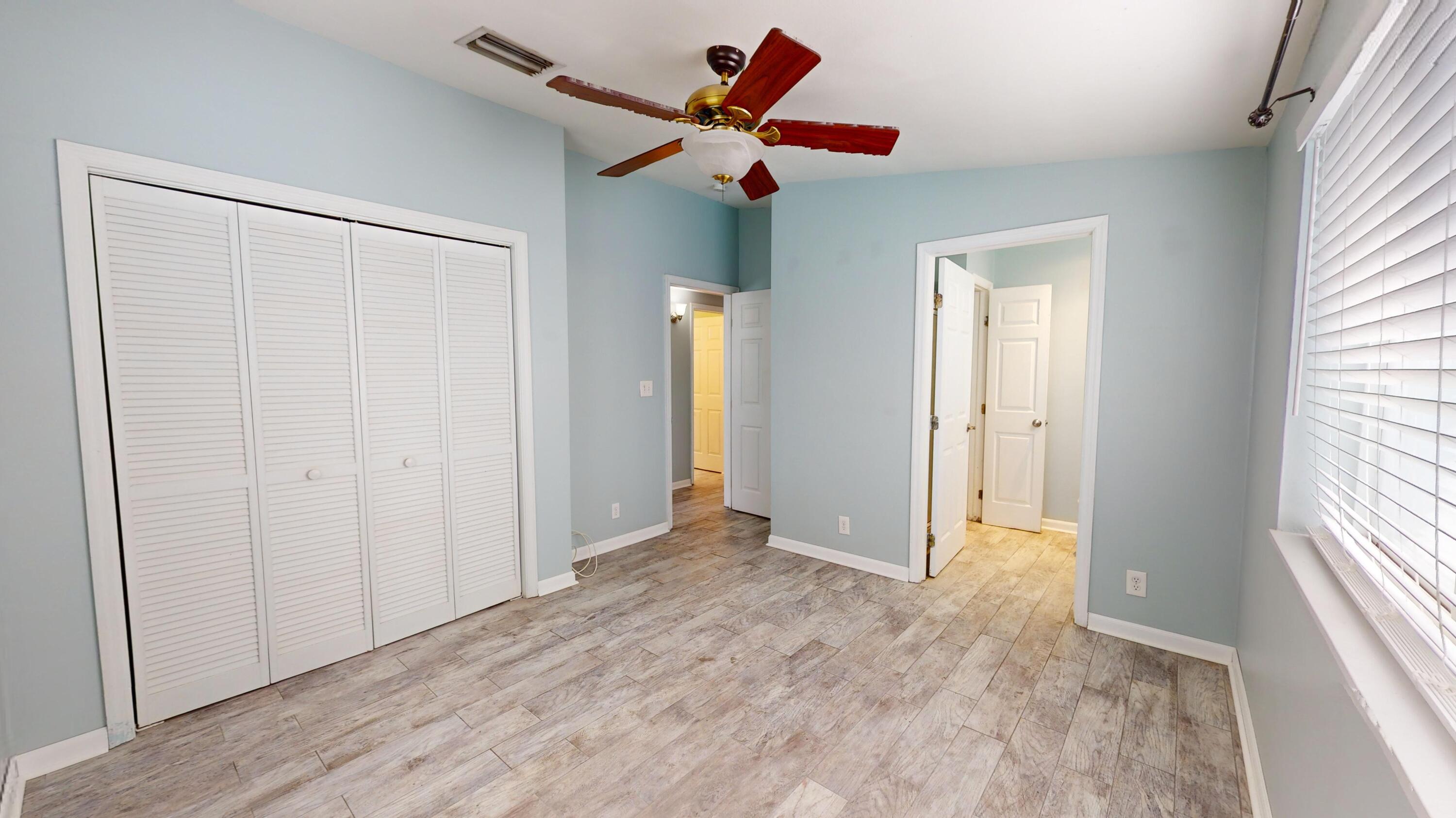 31163 Ave H Big Pine Key, FL 33043 - Photo 8 of 17 wooden floor in an empty room with a window