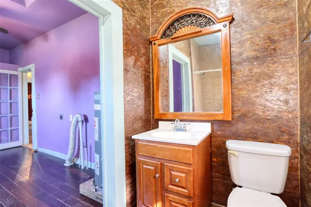 a bathroom with a toilet sink and mirror