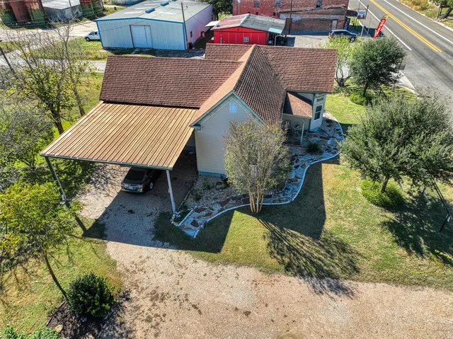 an aerial view of a house with yard and sitting area
