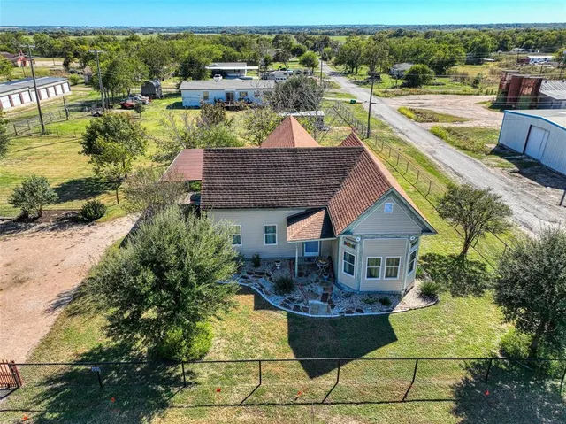 an aerial view of a house with a yard basket ball court and outdoor seating
