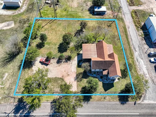 an aerial view of a house with a yard and potted plants