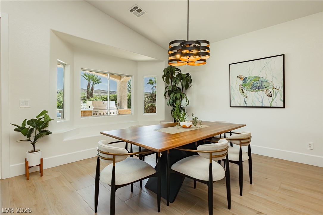 2256 Dogwood Ranch Avenue Henderson, NV 89052 - Photo 23 of 51 Vast windows illuminate this spacious dining area with serene views of the outdoor kitchen.