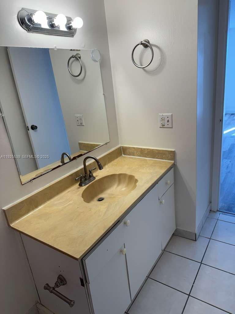 13499 Biscayne Boulevard, Unit 1404 North Miami, FL 33181 - Photo 12 of 13 a bathroom with a sink and vanity