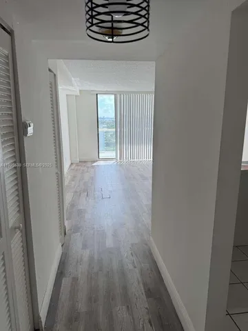 a view of hallway with wooden floor