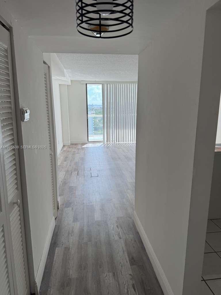 13499 Biscayne Boulevard, Unit 1404 North Miami, FL 33181 - Photo 2 of 13 a view of hallway with wooden floor
