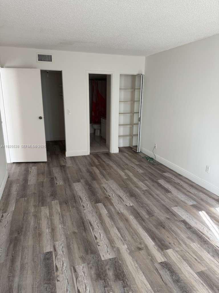 13499 Biscayne Boulevard, Unit 1404 North Miami, FL 33181 - Photo 9 of 13 a view of an empty room with closet and kitchen