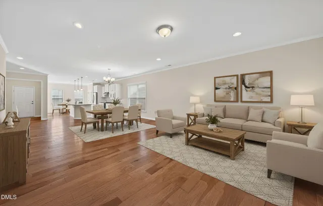 a living room with furniture and wooden floor
