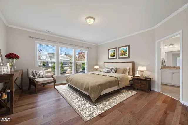 a bedroom with a large bed and a large window