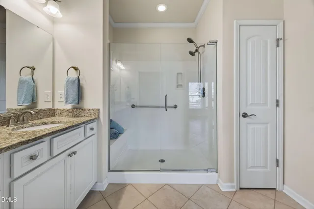 a bathroom with a granite countertop sink a shower and a mirror