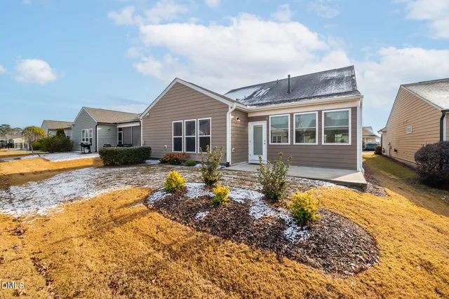 a view of a house with a yard covered in snow