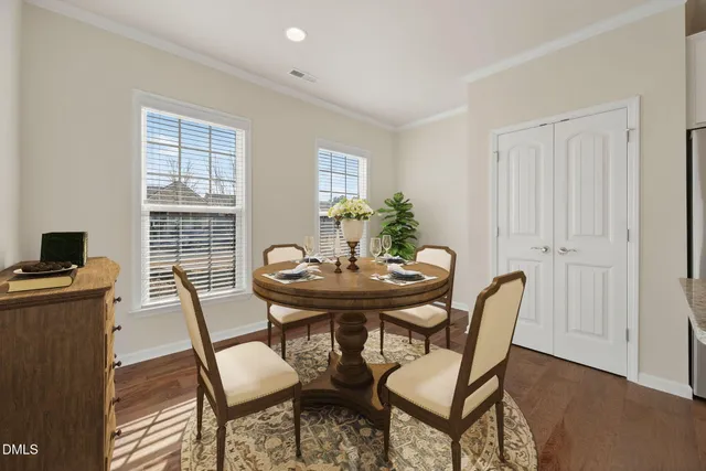 a view of a dining room with furniture and window
