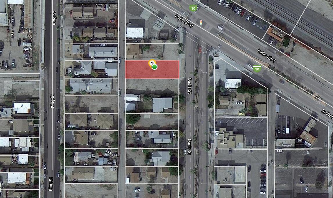 1 Oasis Street Indio, CA 92201 - Photo 2 of 9 a view of a store with a red brick wall