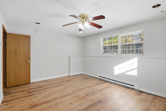 wooden floor in an empty room with a window