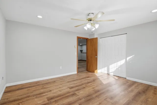 a view of an empty room with wooden floor