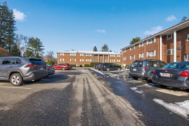 a view of a cars park in front of a building