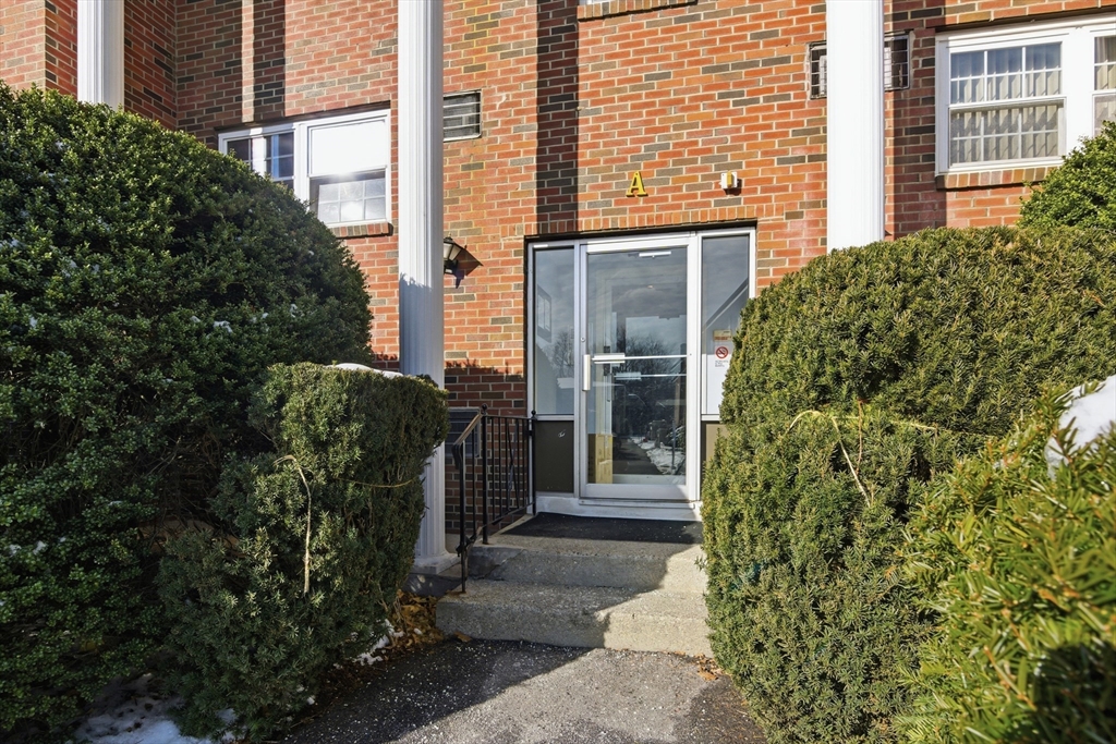 39 Pleasant Street, Unit 7 Northborough, MA 01532 - Photo 3 of 22 a view of a house with potted plants