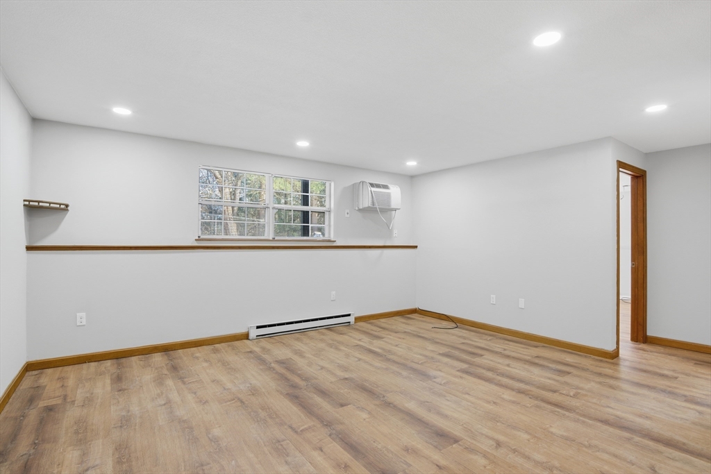 39 Pleasant Street, Unit 7 Northborough, MA 01532 - Photo 8 of 22 an empty room with wooden floor and windows