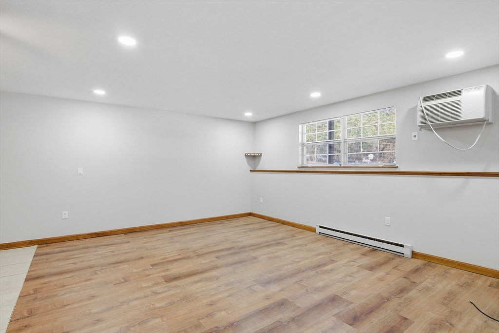 39 Pleasant Street, Unit 7 Northborough, MA 01532 - Photo 9 of 22 an empty room with wooden floor and windows