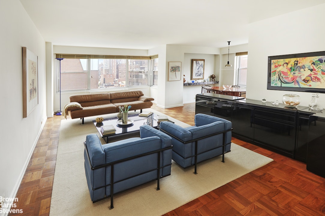 a living room with furniture and a floor to ceiling window