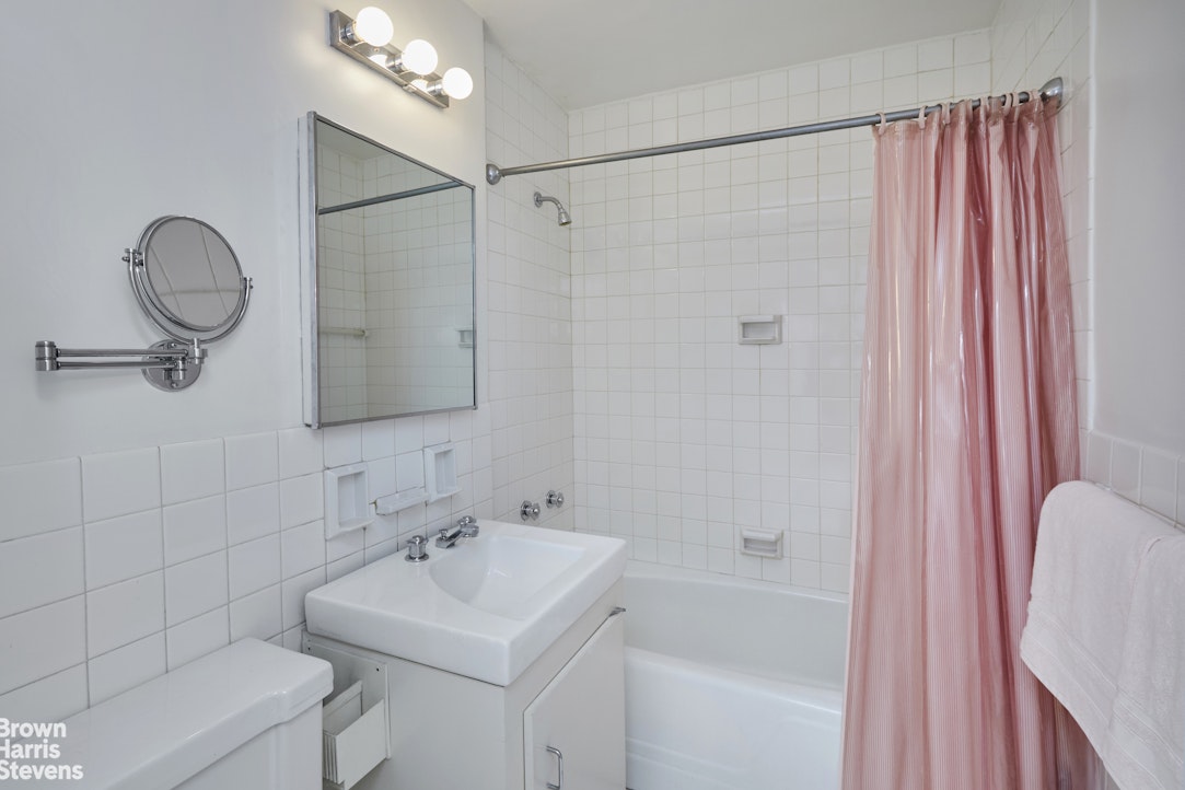 75 East End Avenue, Unit 17A Manhattan, NY 10028 - Photo 10 of 13 a bathroom with a sink a toilet and shower