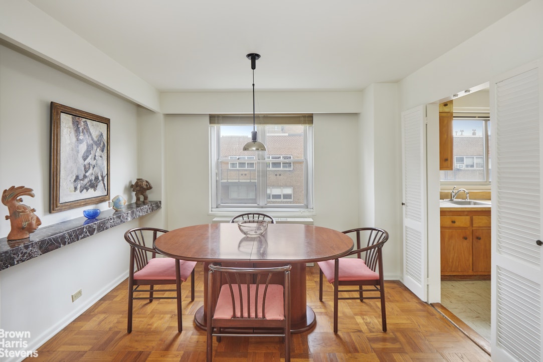 75 East End Avenue, Unit 17A Manhattan, NY 10028 - Photo 4 of 13 a dining room with furniture a chandelier and wooden floor